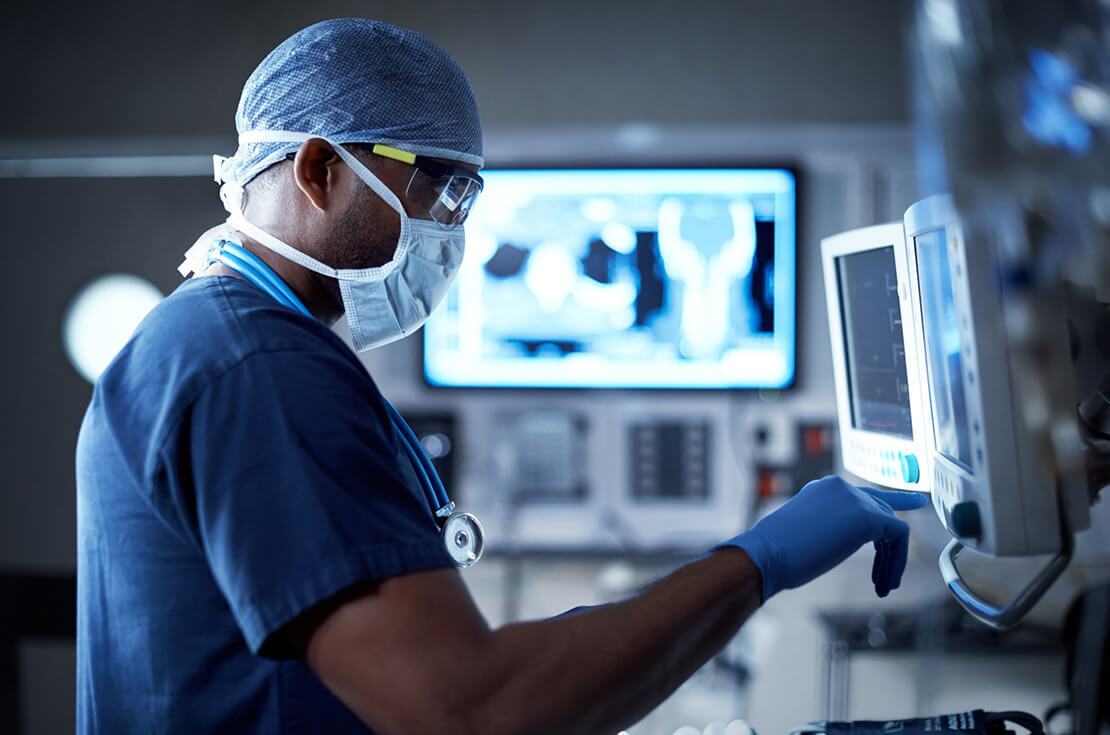 Shot of a surgeon looking at a monitor in an operating room