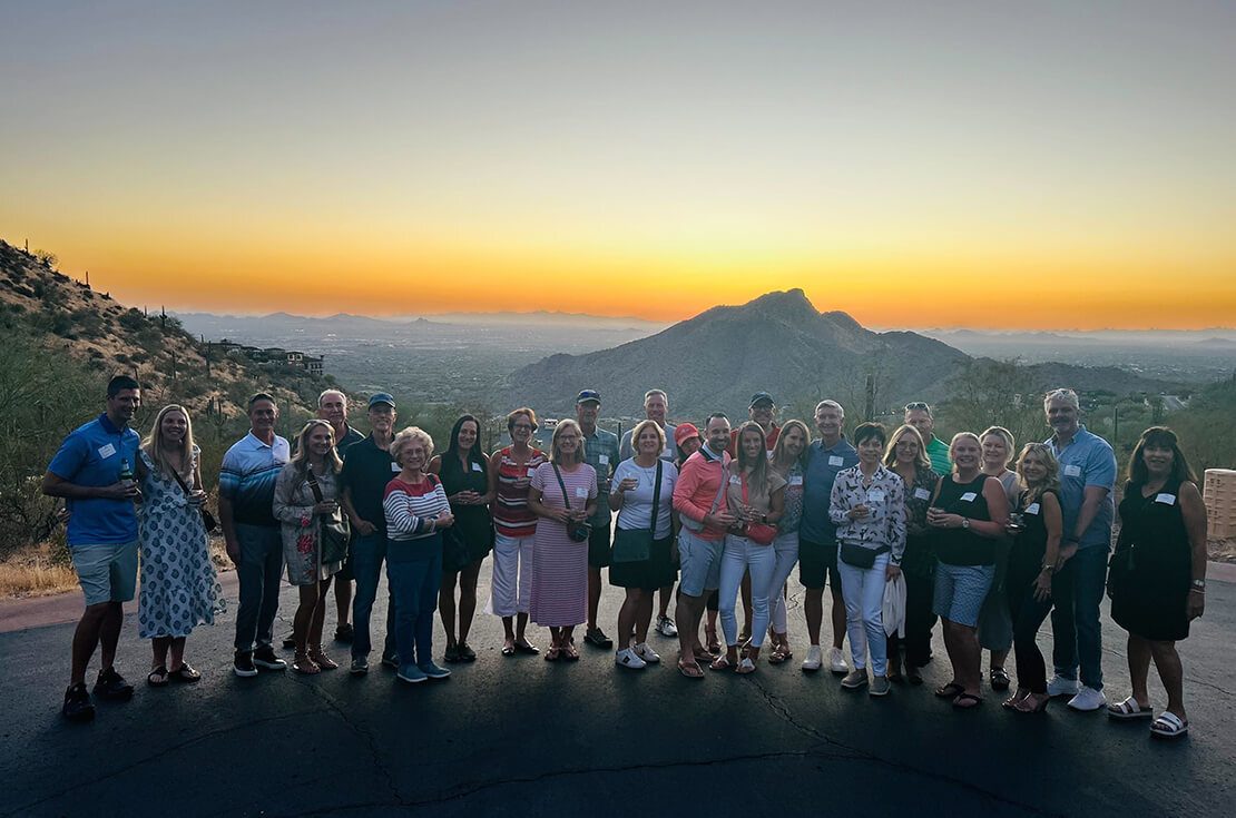 volunteers with sunset by mountains