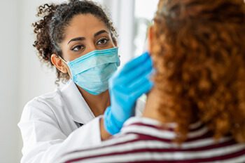 Doctor wearing surgical mask examining